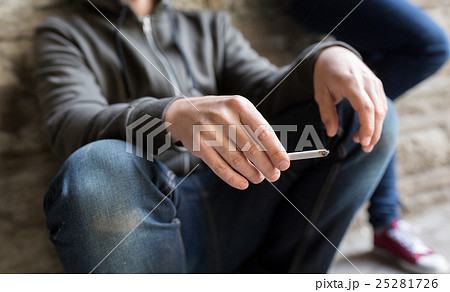 close up of young man smoking cigarette close up of young man smoking cigarette 25281726