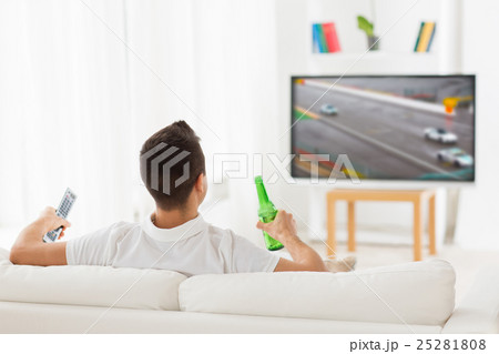 man watching tv and drinking beer at home man watching tv and drinking beer at home 25281808