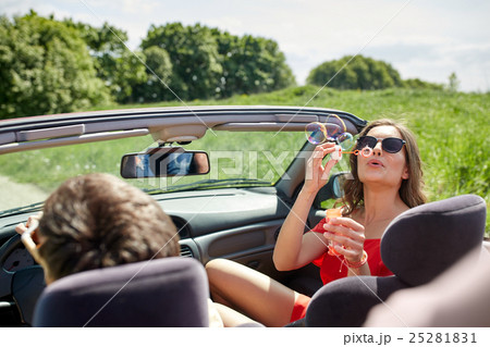 friends driving in car and blowing bubbles friends driving in car and blowing bubbles 25281831