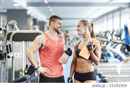smiling man and woman talking in gym smiling man and woman talking in gym 25281929
