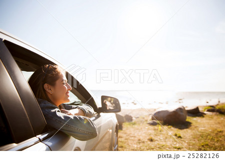 happy teenage girl or young woman in car 25282126