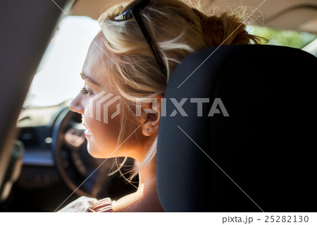 happy teenage girl or young woman in car 25282130