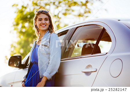 happy teenage girl or young woman in car 25282147