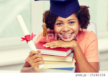 happy african bachelor girl with books and diploma happy african bachelor girl with books and diploma 25282158
