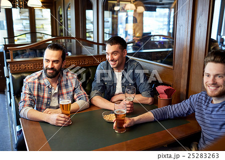 happy male friends drinking beer at bar or pub happy male friends drinking beer at bar or pub 25283263