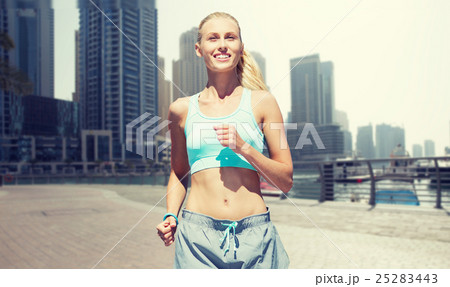 woman running or jogging over dubai city street 25283443