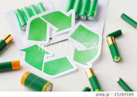 close up of batteries and green recycling symbol 25284589