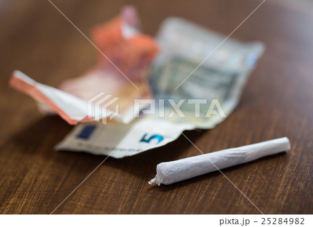 close up of marijuana joint and money close up of marijuana joint and money 25284982