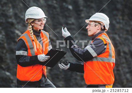 Workers with coal at open pit 25285712
