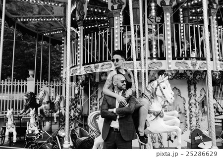 adult man and woman on a carousel 25286629