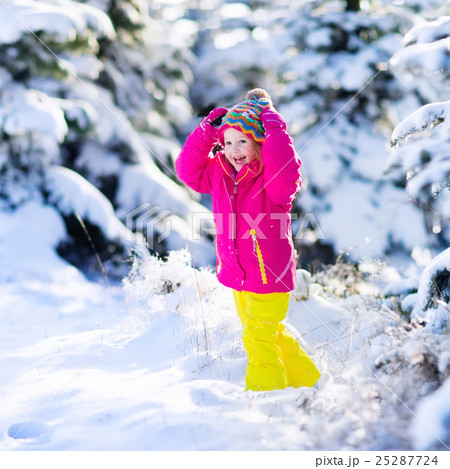 Child having fun in snowy winter park Child having fun in snowy winter park 25287724