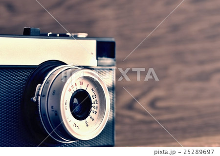 Russian old analog camera on a wooden background. 25289697
