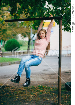 happy girl swinging on the crossbar happy girl swinging on the crossbar 25292042