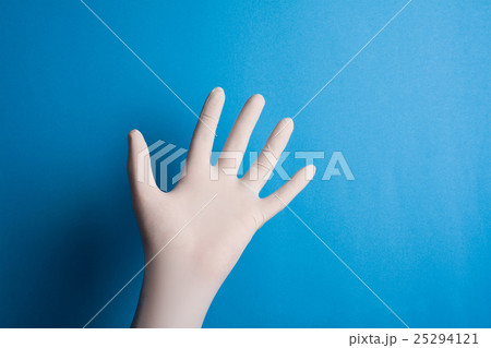 Hand with surgical glove on blue background Hand with surgical glove on blue background 25294121