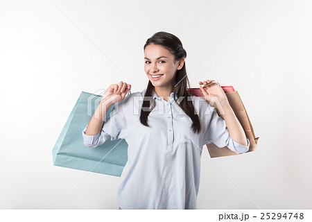 Joyful beautiful woman holding packages Joyful beautiful woman holding packages 25294748