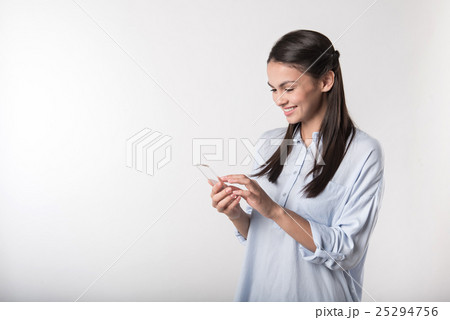 Cheerful woman using cell phone 25294756