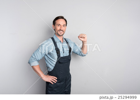 Handsome strong man showing his strength Handsome strong man showing his strength 25294999