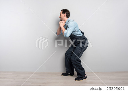 Good looking middle aged man standing in profile 25295001