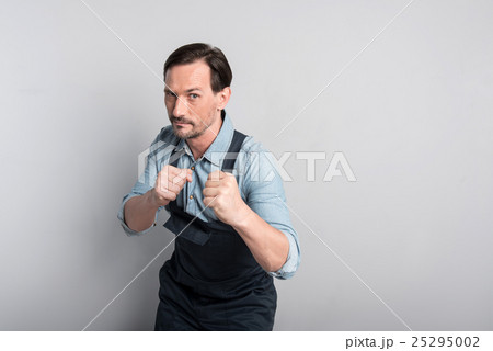 Aggressive athletic man clenching his fists. 25295002