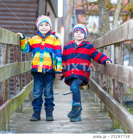 Two little kid boys outdoors in spring town Two little kid boys outdoors in spring town 25297739