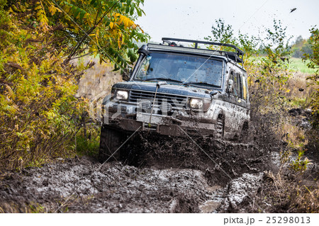 Japaneese SUV moving fast by deep mud 25298013