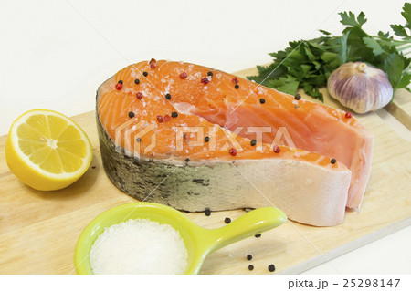 Row salmon with pepper and salt on a board 25298147