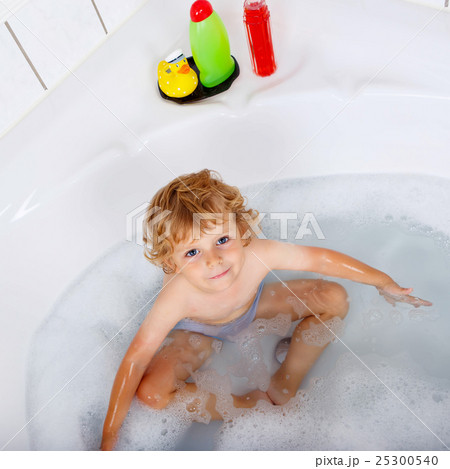 toddler boy playing in bathtub at home toddler boy playing in bathtub at home 25300540