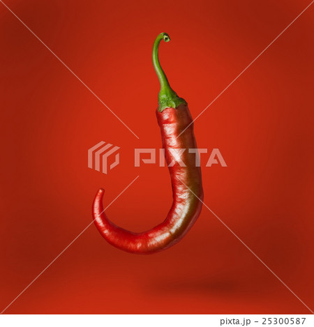 Hot chilli pepper floating over 25300587