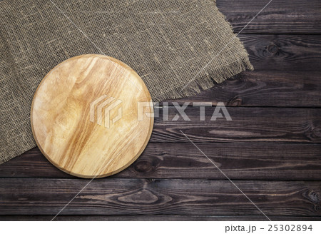 Cutting board on wooden table, top view Cutting board on wooden table, top view 25302894