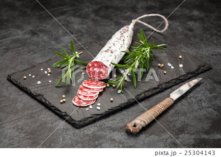 Salami on dark background 25304143