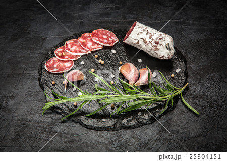 Salami on dark background Salami on dark background 25304151