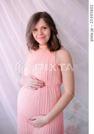 Happy pregnant young woman waiting for a child Happy pregnant young woman waiting for a child 25305602