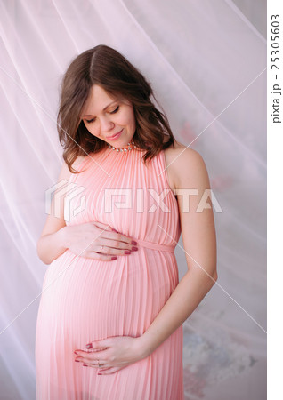 Happy pregnant young woman waiting for a child Happy pregnant young woman waiting for a child 25305603