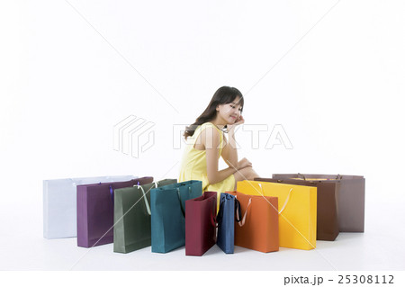 A young woman carrying a bunch of shopping bags A young woman carrying a bunch of shopping bags 25308112