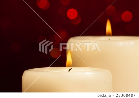 close-up of candles with flame on red bokeh close-up of candles with flame on red bokeh 25308487