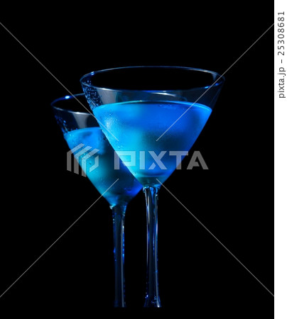 glasses of fresh cocktail with ice on bar table on black background glasses of fresh cocktail with ice on bar table on black background 25308681