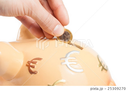 hand inserting a coin into a piggy bank, concept for business and save money hand inserting a coin into a piggy bank, concept for business and save money 25309270