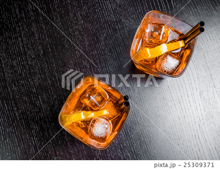 top of view of two glasses of spritz aperitif aperol cocktail with orange slices and ice cubes top of view of two glasses of spritz aperitif aperol cocktail with orange slices and ice cubes 25309371