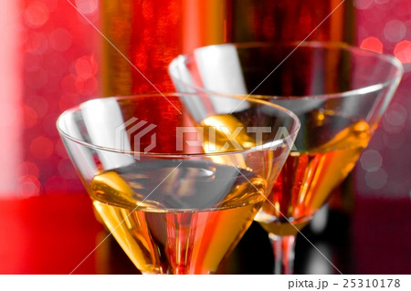 detail of glasses of cocktail on bar table in front of bottles detail of glasses of cocktail on bar table in front of bottles 25310178