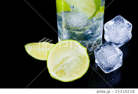 detail of cocktail with ice and lime slice and space for text detail of cocktail with ice and lime slice and space for text 25310218