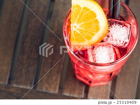 top of view of spritz aperitif aperol cocktail with orange slices and ice cubes 25310409