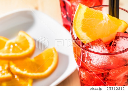top of view of glass of spritz aperitif aperol cocktail with orange slices and ice cubes 25310812