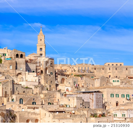 panoramic view of typical stones (Sassi di Matera) and church of Matera under blue sky panoramic view of typical stones (Sassi di Matera) and church of Matera under blue sky 25310930