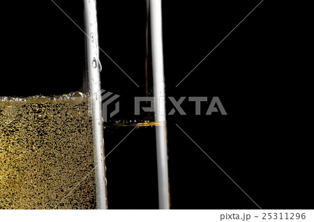 detail of a pair of flutes of champagne with golden bubbles detail of a pair of flutes of champagne with golden bubbles 25311296