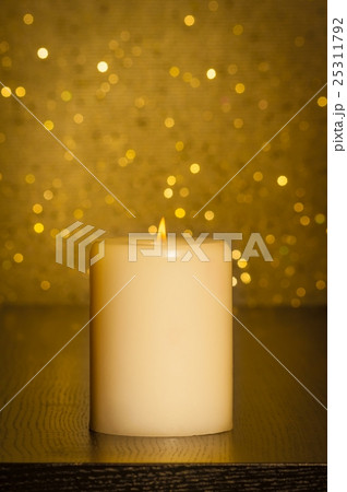 candle with flame on wood table candle with flame on wood table 25311792