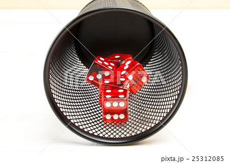 red dice inside a container 25312085