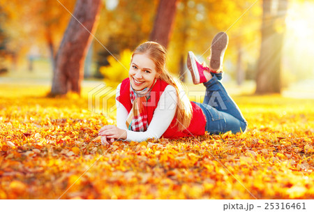 happy young woman resting outdoors in autumn 25316461