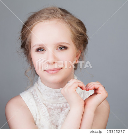 First Love. Cute Girl Smiling and Making Heart 25325277