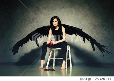 Cruel Love. Woman Black Angel Peeling a Red Heart Cruel Love. Woman Black Angel Peeling a Red Heart 25326144