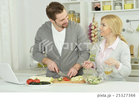 happy couple cooking in kitchen 25327366